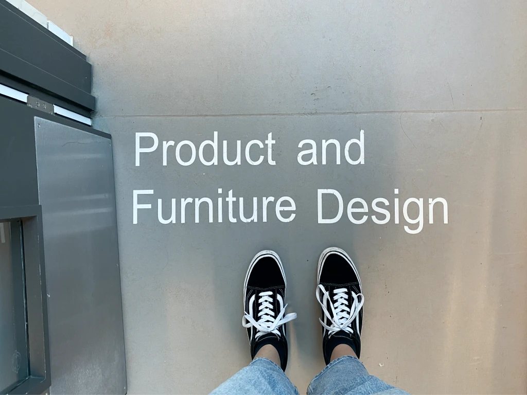 Feet on a floor printed with the words Product and Furniture Design